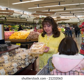 Native American Woman Reading Labeling On A Confection Package In A Grocery Store