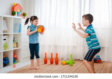 Native Children Boy And A Girl Play In A Children's Game Room, Throwing Ball. Concept Of Interaction Siblings , Communication, Mutual Play, Quarantine, Self-isolation Home, Brother Sister.