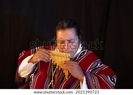 Native Ecuadorian indigenous musician play Pan Flute