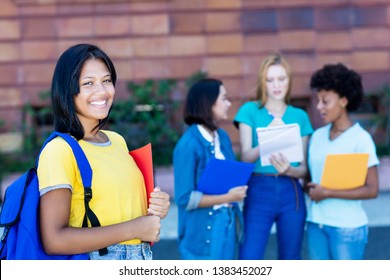 Native Latin American Female Student With Group Of Students Outdoor In Summer At University