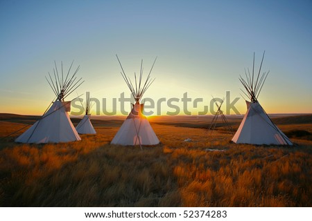 Native North American tipis at sunrise on the plains