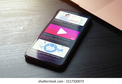 Native Online Advertising concept. Programmatic targeted ads marketing strategy. Advertising media banner block on website on the screen of the smartphone lying on the wooden table. High quality photo - Shutterstock ID 2117320073