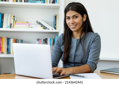 Native South American Woman Working At Computer At Office