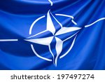 NATO Flag - Close-up photo of waving original and simple NATO flag. NATO is an intergovernmental military alliance based on the North Atlantic Treaty which was signed on 4 April 1949.