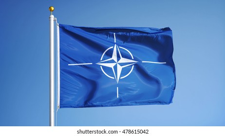 NATO Flag Waving Against Clean Blue Sky, Close Up, Isolated With Clipping Path Mask Alpha Channel Transparency