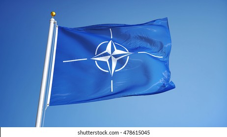 NATO Flag Waving Against Clean Blue Sky, Close Up, Isolated With Clipping Path Mask Alpha Channel Transparency