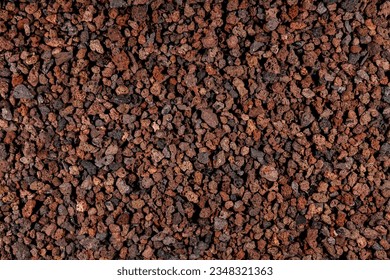 Natural aquarium lava gravel in red brown colors. Volcano lava mulch chippings mineral stones ground
