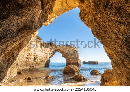 Natural arch above ocean, Algarve, Portugal. View of the natural stone arch during beautiful sunny day.
Turism concept