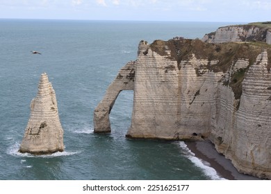 a natural arch and a spiky rock at the white cliffs at the french coast in normandy - Shutterstock ID 2251625177