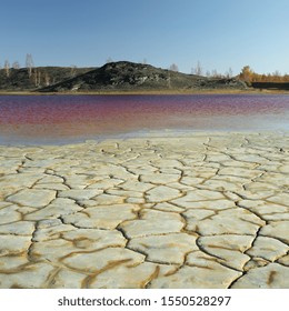 Natural Area On The Background Of A Pond With Red Water Poisoned Waste Copper Smelting Production, City Of Karabash, Chelyabinsk Region, Russia.