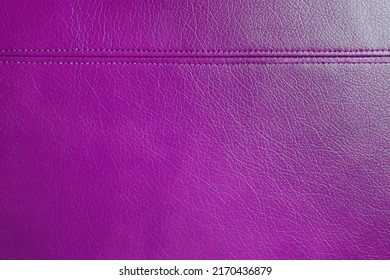 Natural, artificial purple leather texture background with decorative seam. Material for sport items, clothes, furnitre and interior design. ecological friendly leatherette.