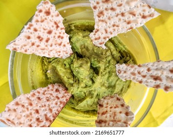 Natural avocado salad and matzoh pieces. Israeli Mediterranean Snack for Pesach. Healthy, tasty, festive