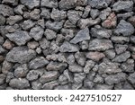 Natural background image formed by rough basalt rocks