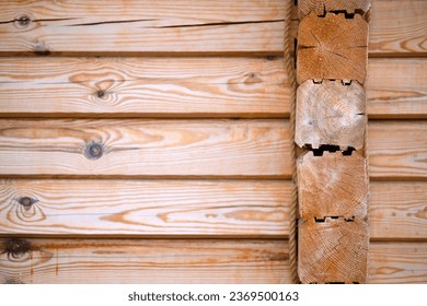 Natural background pattern of log wall. Construction of houses made of wood, profiled timber.