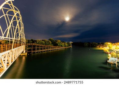 The natural background of the waterfront forest, with a wooden bridge to admire the scenery around, the atmosphere is surrounded by (trees, wind, sunlight, sky, grass, leaves) - Powered by Shutterstock
