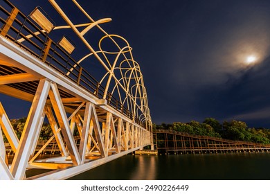 The natural background of the waterfront forest, with a wooden bridge to admire the scenery around, the atmosphere is surrounded by (trees, wind, sunlight, sky, grass, leaves) - Powered by Shutterstock