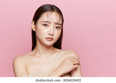 Natural beauty concept of a young Asian woman on a pink background