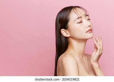 Natural beauty concept of a young Asian woman on a pink background