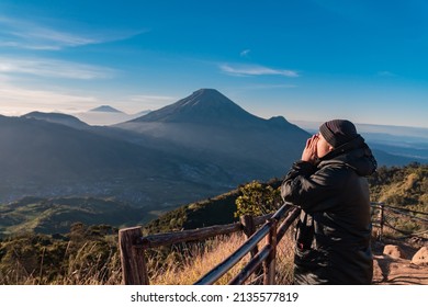 The natural beauty of the peak of Sikunir from the Dieng Plateau at sunrise, Mount Sindoro is clearly visible and the surrounding hills are truly stunning.