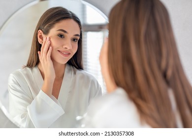 Natural Beauty. Portrait Of Attractive Young Female Smiling To Her Reflection In Mirror, Beautiful Millennial Woman Enjoying Her Appearance While Getting Ready In Bathroom, Selective Focus - Shutterstock ID 2130357308