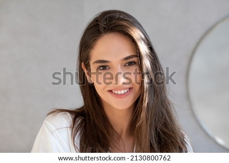 Natural Beauty. Portrait Of Happy Attractive Young Lady Looking At Camera, Beautiful Millennial Woman With Smooth Perfect Skin And Thick Hair Posing In Bathroom At Home, Enjoying Her Appearance