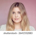 Natural beauty and skincare elegance, blonde woman with soft waves and blue eyes posing against a pink background with smooth make-up and glowing skin