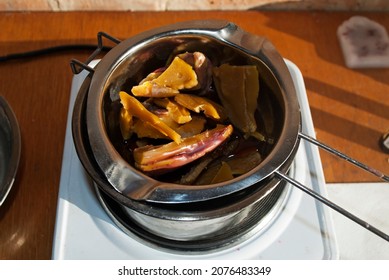 Natural Beeswax For Making Candles. Homemade Candle Making. Wax In The Process Of Melting In A Metal Dish On An Electric Stove, Water Bath. 