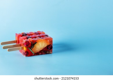 Natural Berry and Fruit Tea Flavour Popsicles on Blue Background Summer Refreshing Delicious and Healthy Treat or Desserts Popsicle for Tea Horizontal