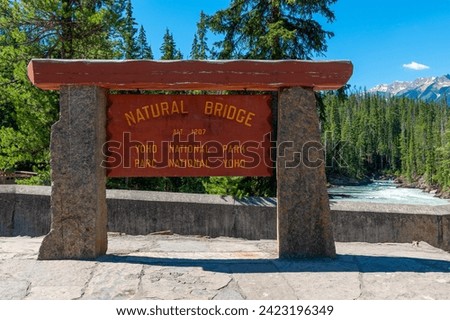 Natural Bridge rock formation sign by the Kicking Horse River, Yoho national park, British Columbia, Canada.