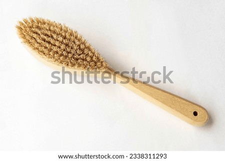 Natural bristle brush with wooden handle for dry massage isolated on white background