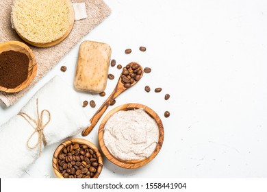 Natural Coffee cosmetic on white background. Scrub, soap, seasalt and coffee. Spa, body care concept. Flat lay image with copy space.