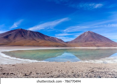 The natural colors of the green lagoon in the Siloli desert near the border of Chile and the Uyuni Salt Flat in Bolivia, South America