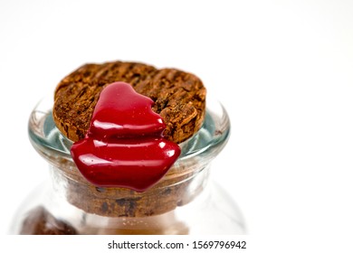 Natural cork in a glass bottle sealed with red sealing wax filmed on a large white background. - Powered by Shutterstock