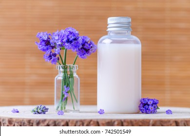 natural cosmetic bottle with fresh lavender flowers, selective focus