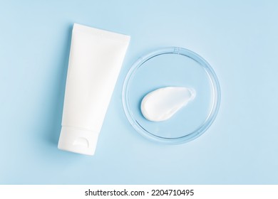Natural Cosmetic Laboratory Concept. Petri Dish With Cosmetic Cream, White Cream Tube On Blue Background Top View, Mockup