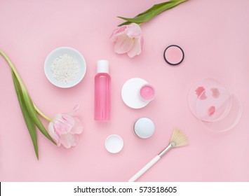 Natural cosmetic pink flat lay with flowers. Top view.