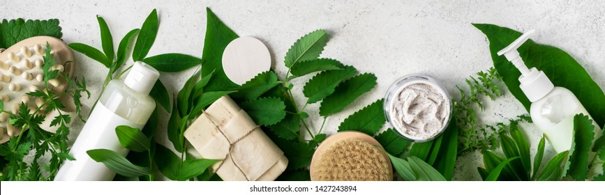 Natural cosmetics and green leaves on white stone background, banner. Natural organic skincare, bio research and healthy lifestyle concept. - Shutterstock ID 1427243894
