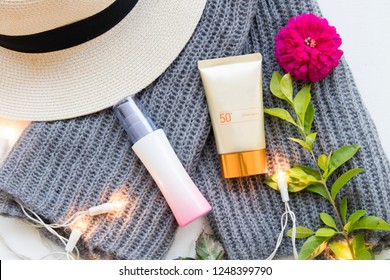 Natural Cosmetics For Skin Face Sunscreen Spf50 ,knitting Wool Scarf ,perfume Spray,hat  Of Lifestyle Woman Relax Winter On Background White Flat Lay Style