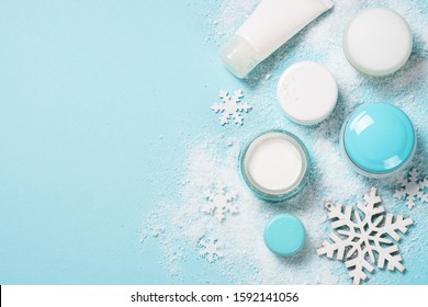 Natural Cosmetics For Winter. Winter Cream For Face, Hands And Body, Skincare Product. Top View On Blue Background.