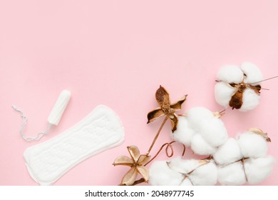Natural cotton menstrual pad, sanitary napkin and tampon, soft and delicate like cotton, on a pink background. Feminine hygiene items.