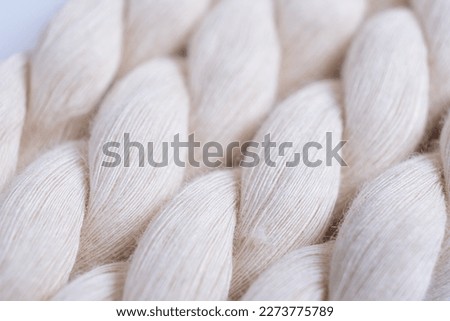 Natural cotton rope curl. Thick strong hemp cotton rope showing detail of threads and fibres, close up