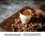 Natural craft cocoa drink on wooden tray, organic healthy chocolate drink with brown cocoa beans and dry cacao pod