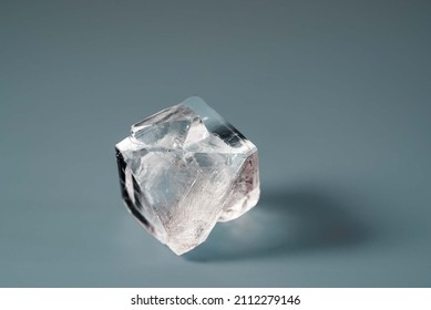 Natural Crystal Of The Mineral Raw Diamond On A Blue Background