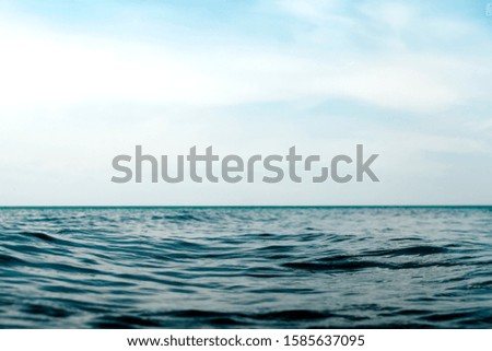 Natural dark blue seawater surface with blue sky