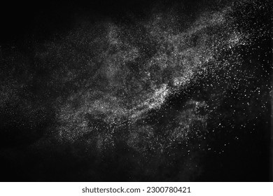 Natural dust particles flow in air on black background