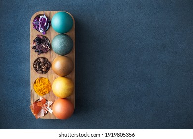 Natural dye for easter eggs - red cabbage, carcade, coffee, turmeric and onion skin. Homemade colored easter eggs with ingredients. Copy space, mock up