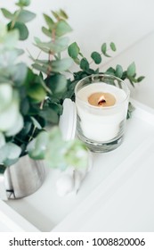 Natural Eco Home Decor With Green Leaves And Burning Candle On T