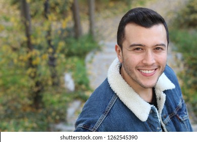 Natural ethnic man smiling outdoors with copy space