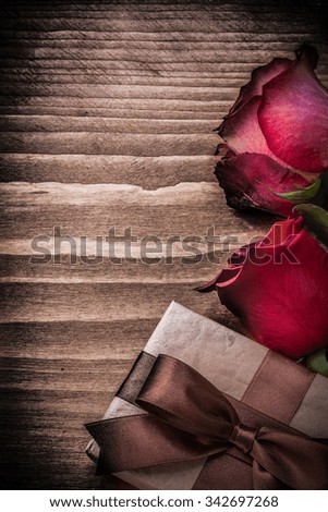 Natural expanded roses present box on wood board holidays concept.