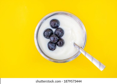 Natural Flavor White Yogurt In Stainless Steel Cups And Stainless Steel Spoons. Topping With Grapes Fruits With A Sweet And Sour Taste.
Yellow Background